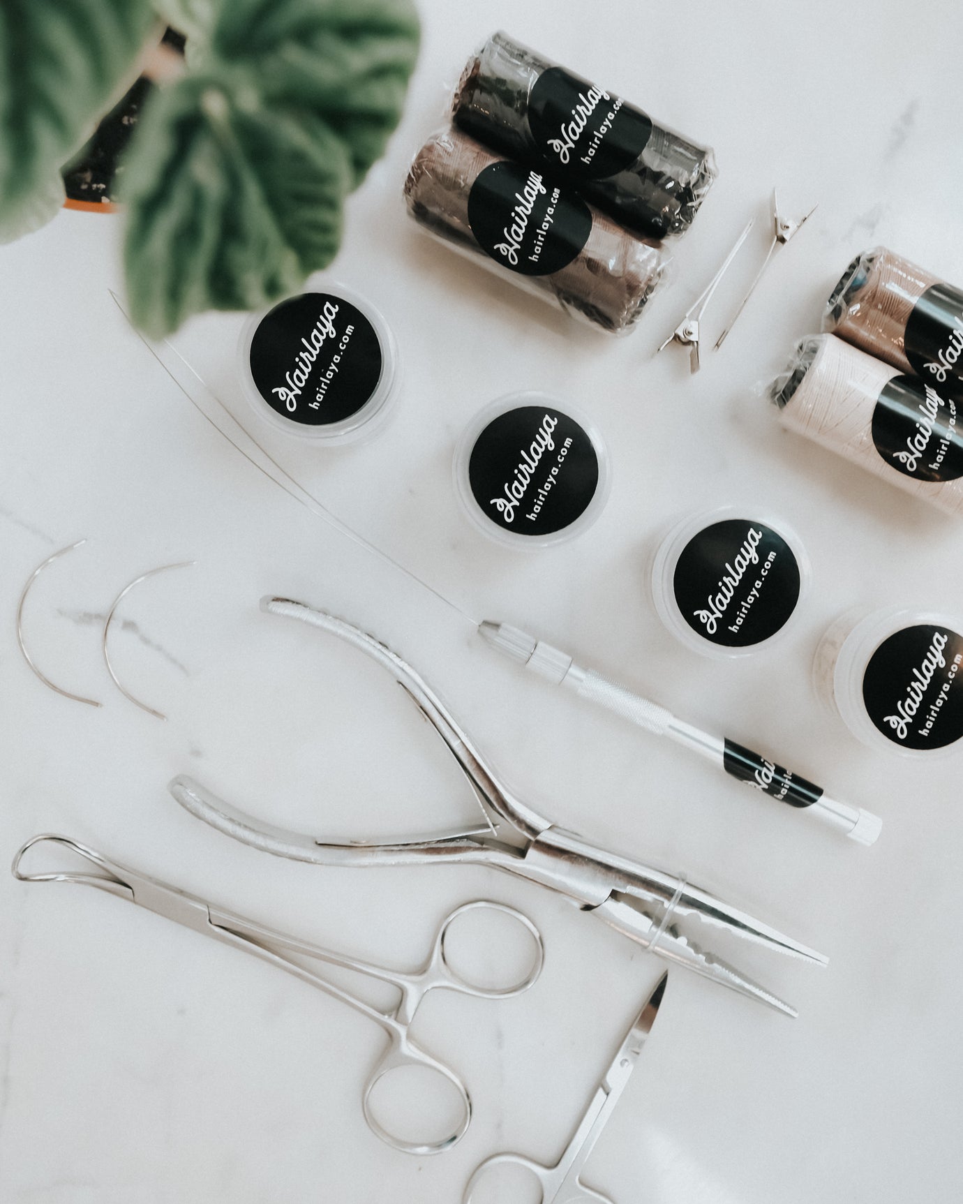 Tools used to install and maintain Hairlaya hand-tied extensions.