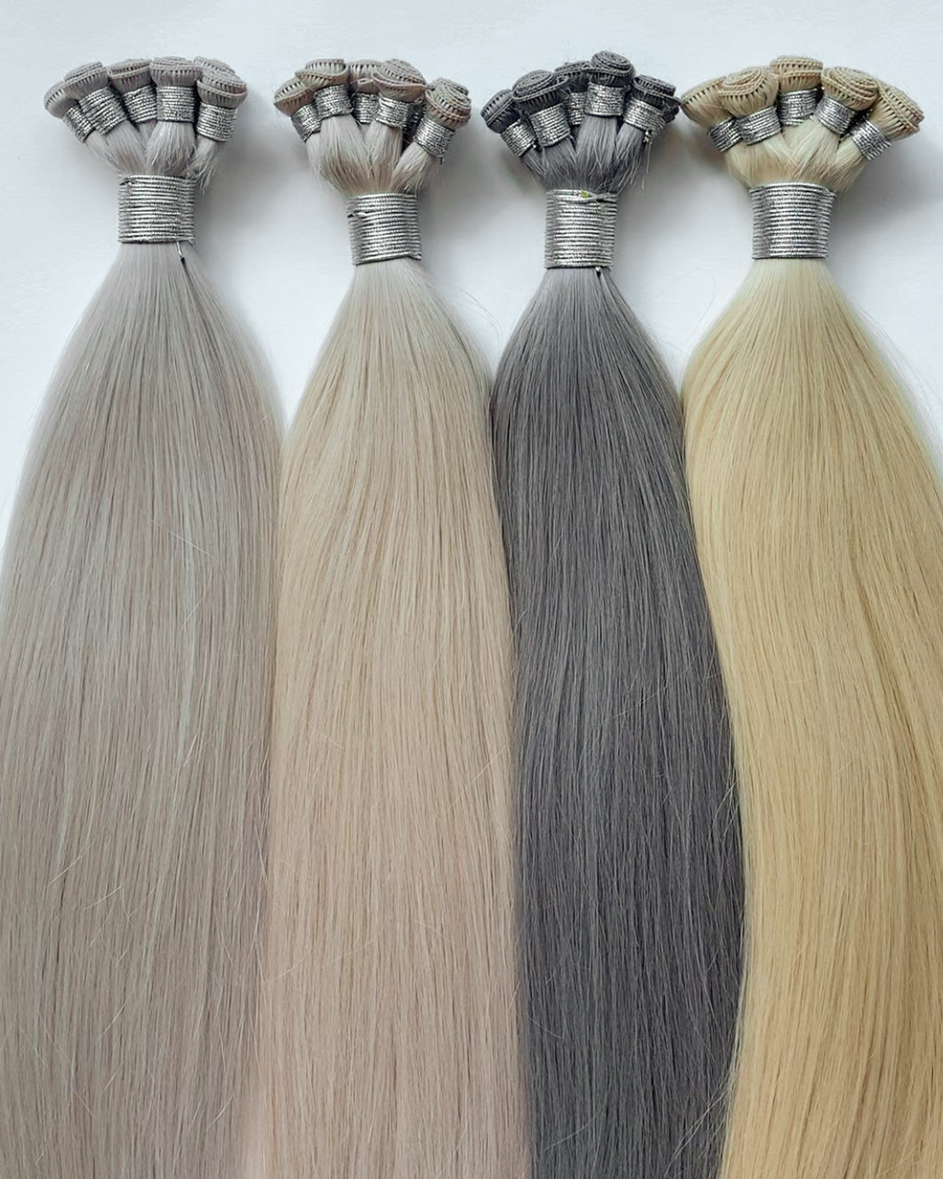 Bundles of Hairlaya hand-tied extensions in different colors.